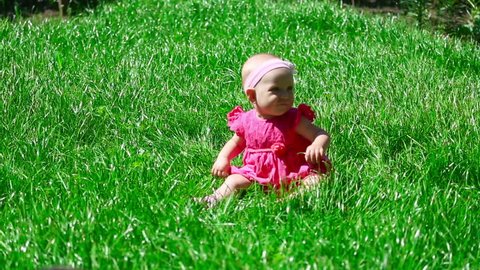 Seven month baby sitting on a lawn