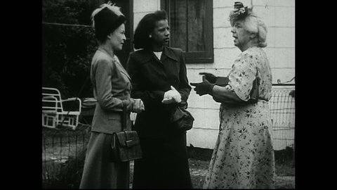 United States 1950s. Women of various ages and races have conversations Outside of a house and a business.