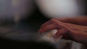 Footage of a woman playing piano close up shoot. 