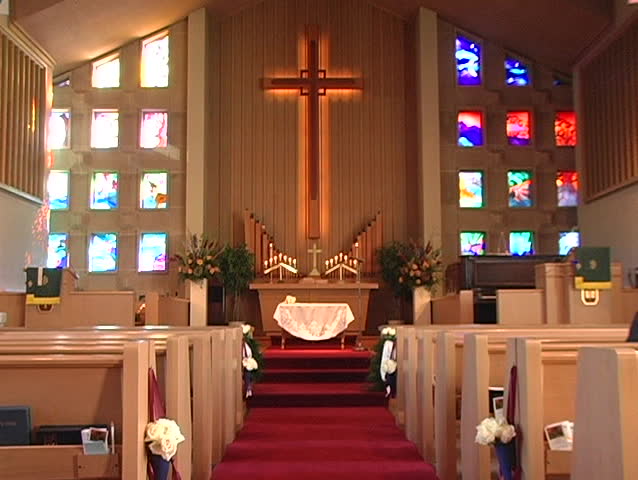 Looking at the stained glass of the altar at a church.