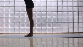 Woman practicing yoga in a studio indoors