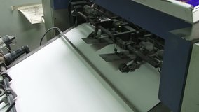 Printed sheets coming out of commercial printing press