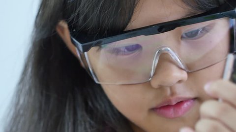 Little Asian student girl making science experiments. Education, Close up shot