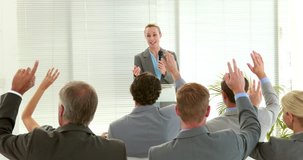 Video of businesswoman giving conference and business people asking question during meeting
