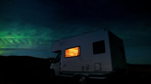 Camper van RV motor home in winter iceland northern lights night sky view travel destination adventure off the beaten track for a once in a lifetime experience - 4k time lapse timelapse