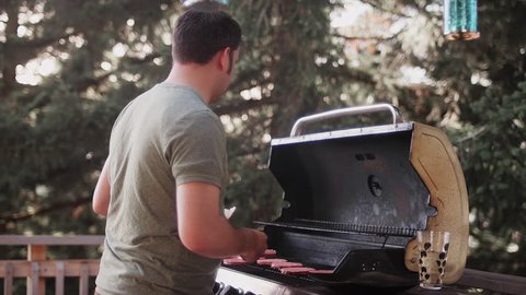 A man making hamburgers on a barbecue