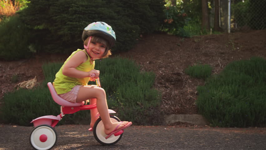 girl riding tricycle