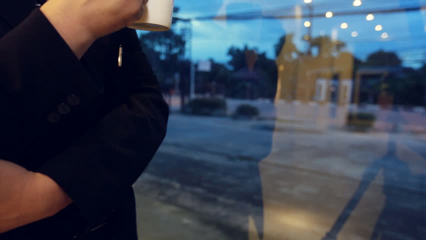 Asian business Man drinking coffee at night in cafe. Handsome man waiting someone, Bangkok Thailand