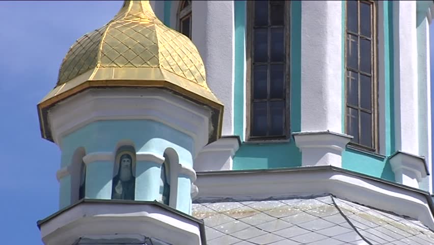 Bell Tower With Golden CupolaClose Up With Semicircular Windows Image on the Tower Blue and White Walls Columns Temple of Kievo-Pecherska Lavra, sunlight and shadow on the wall, sunny, summer,