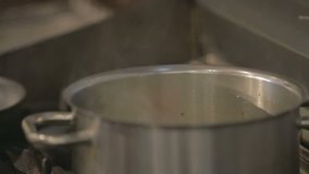 Steaming pot of food in a professional kitchen - Powered by Shutterstock - Get 15% off with code: PIKWIZARD15