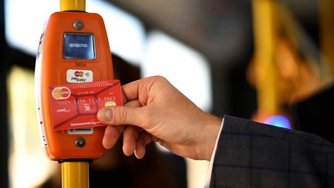 ST. PETERSBURG, RUSSIA - AUGUST 17, 2015: Vice president of Mastercard in Russia Anton Shigapov demonstrate the PayPass technology in transport ticketing system implemented in the line 5 trolleybus