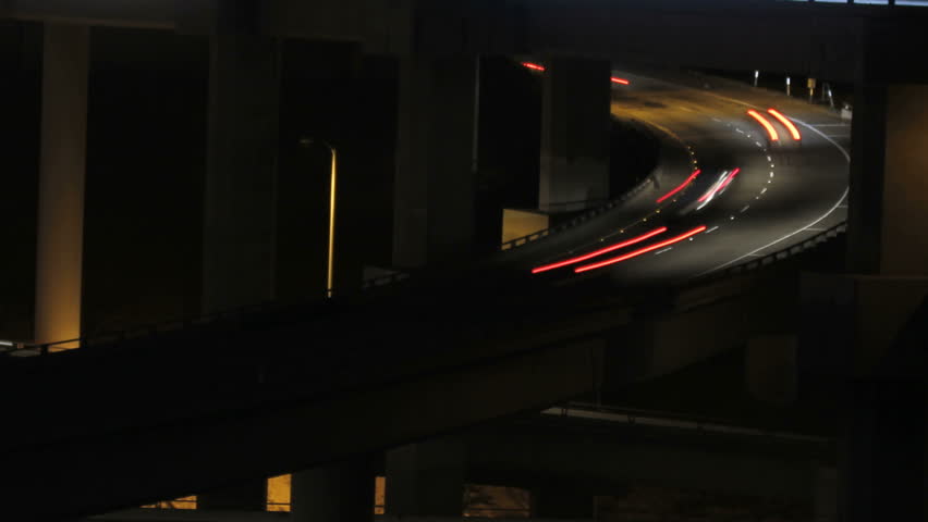 This is a time lapse shot at night of a multi level freeway interchange
