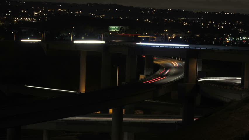 This is a time lapse shot at night of a multi level freeway interchange
