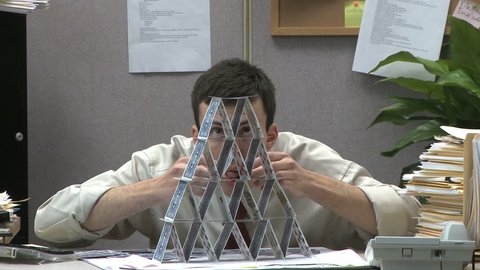 man building house of cards