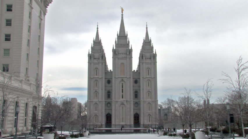 Video of the Mormon Temple in Salt Lake City Utah. Church of Jesus Christ of Latter-Day Saints, Mormon.  Visitors walking. Hotel Utah left.  