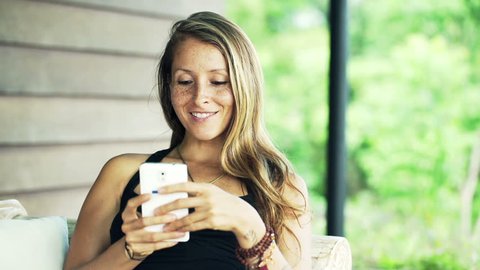 Young, pretty woman using smartphone 
