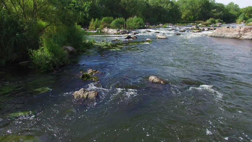 Aerial: flying over river rapids