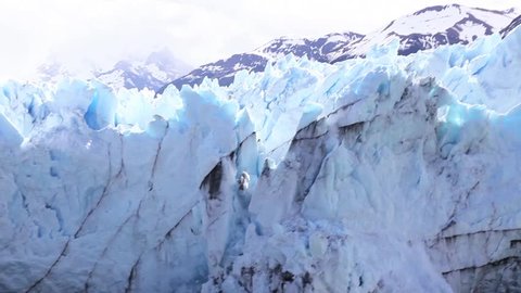 Iceberg falls from ice shelf.