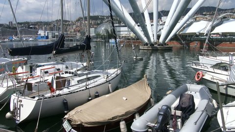 GENOA, ITALY - AUGUST 22: Sailing boats docked in front of the aquarium in the old port, on August 22, 2015 in Genoa, Italy