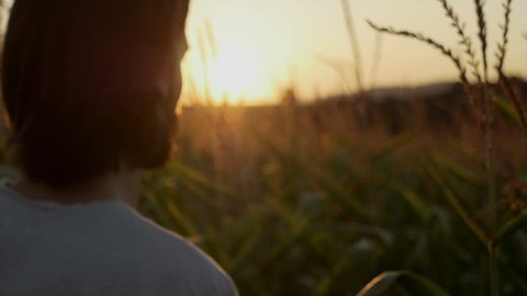 Handsome man with beard with nature landscape in sunset/sunrise. Close up. 
