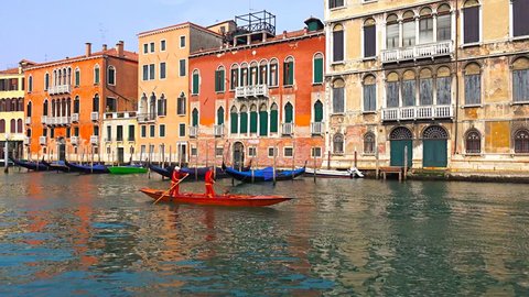 VENICE, ITALY - circa APRIL, 2015:  Rowing team training on small boat on Canal Grande in Venice, Italy. Vibrant houses with water reflection