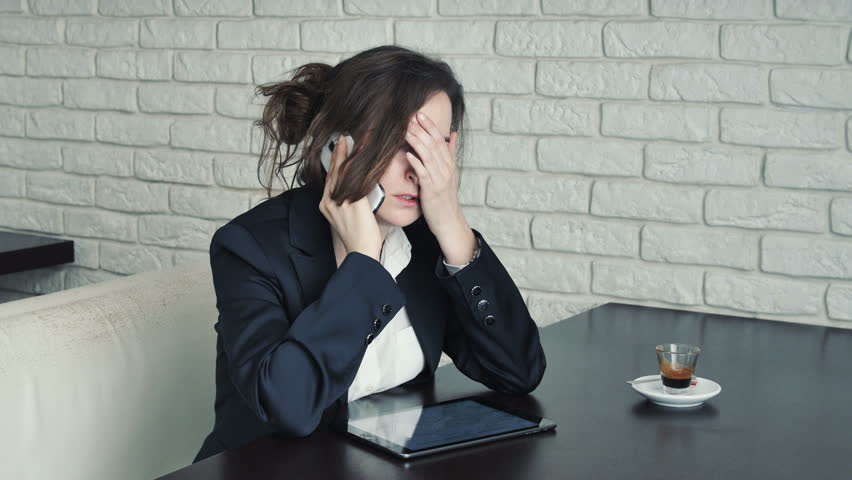 Worried and hungry businesswoman in a cafe with a tablet computer and smartphone | Shutterstock HD Video #11526269