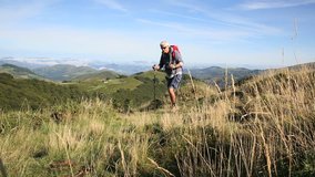 Trekker walking on top of Pyrenees mountains, Basque Country