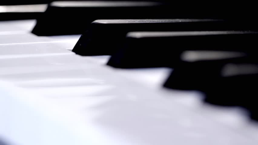 Close up of piano keys (dolly shot)