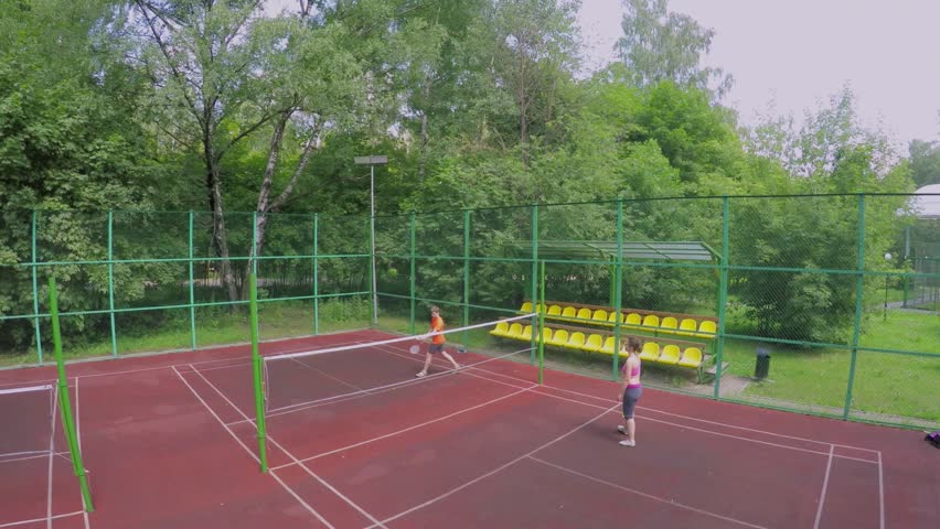 Badminton playground where mother play with son badminton at summer sunny day in park. Aerial view Royalty-Free Stock Footage #11538851