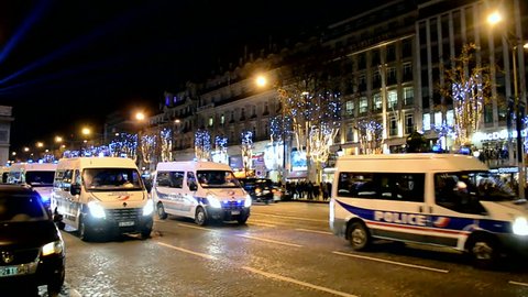 PARIS - DEC 31: police cars near Arc de Triumphe (AKA Arch of Triumph of the Star) on Avenue des Champs-Elysees in Paris decorated with Christmas illumination in Paris, France on December 31, 2014. 