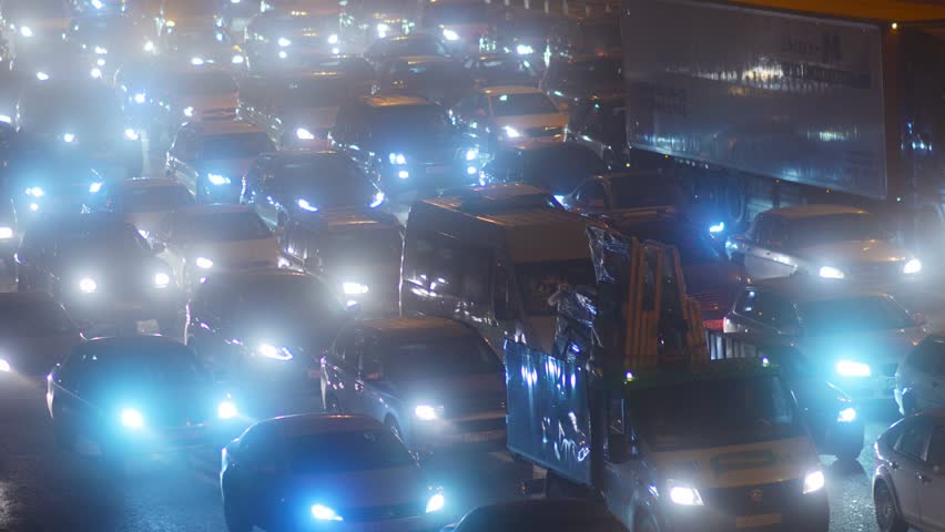 MOSCOW, RUSSIA - CIRCA SEPTEMBER 2015: Traffic jam, dense slow flow of cars on a freeway at foggy night. | Shutterstock HD Video #11553818
