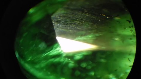 Natural colombian emerald 1,6 carat oval cut from Muzo mines under microscope, magnification 40X: film stockowy