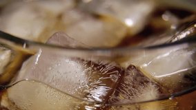 Pouring Cola with Ice and bubbles in glass background