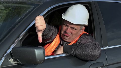 Worker in car showing thumb down