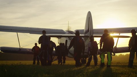 Group of Skydivers Moving Towards Airplane in Sunset Light. Shot on RED Cinema Camera in 4K (UHD).