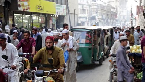 PESHAWAR, PAKISTAN - NOVEMBER 01, 2015:Traffic slowly makes its way through a busy road, next to the main namak mandi bazaar in Peshawar,pakistan