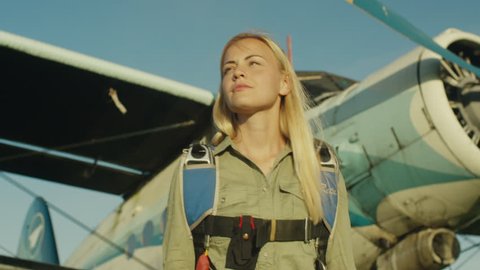 Girl Skydiver is Walking on Airfield. Shot on RED Cinema Camera in 4K (UHD).