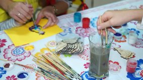 children paint colors on the table, brushes for painting