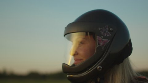 Smiling Girl Skydiver is Taking off the Helmet after Successful Landing. Shot on RED Cinema Camera in 4K (UHD).