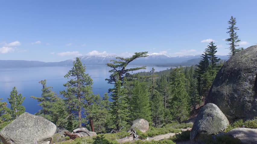 Flying low past boulders and through trees to Lake Tahoe and Emerald Bay very close to trees.