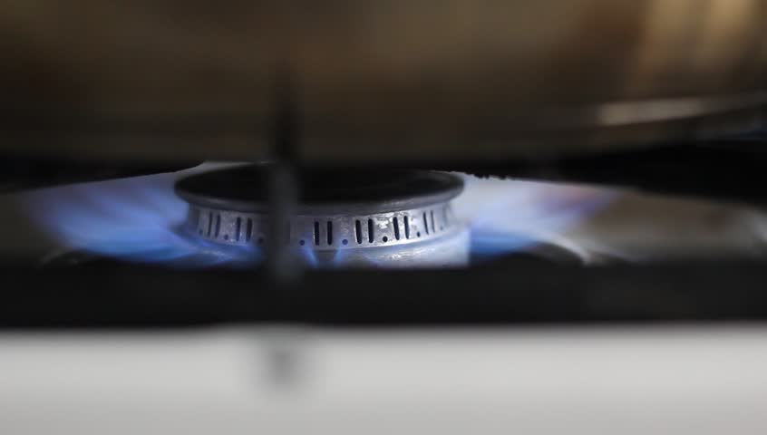 A gas flame on a stove top burner