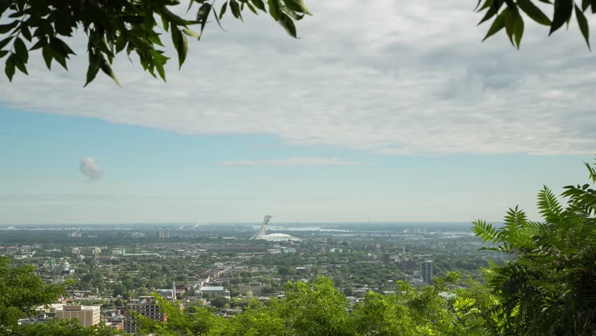 Montreal, Canada - August 2015. A Time lapse taken from Mont Royal overlooking the East end of Montreal and the Olympic Stadium. Royalty-Free Stock Footage #11593817
