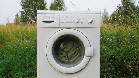 White washer machine on nature background
