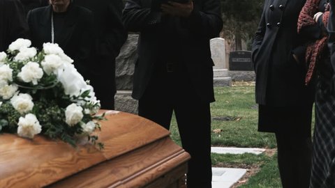 priest giving a eulogy at a funeral