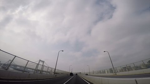 TOKYO, JAPAN - CIRCA MAY 2015: Rainbow Bridge in Tokyo Bay. POV drive. 1080p HD.