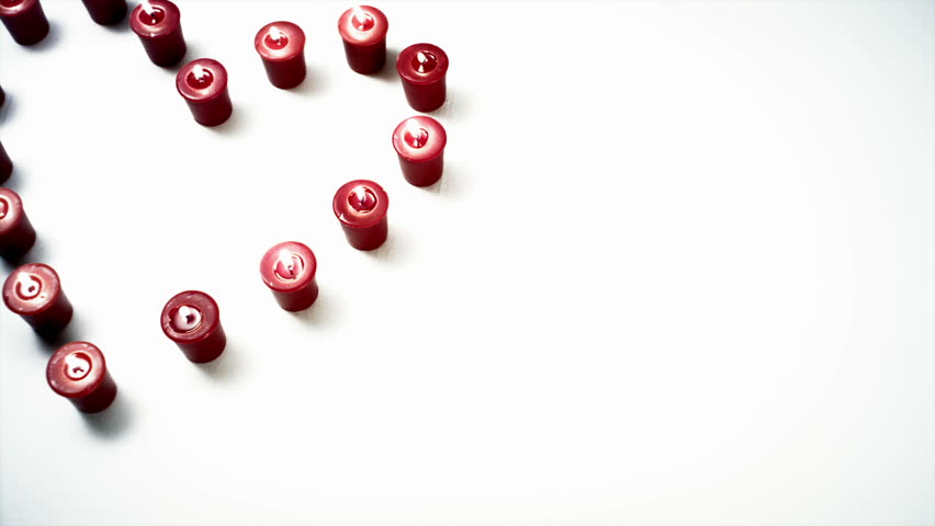 Red & White Candles in the shape of a heart against white backgrounds.