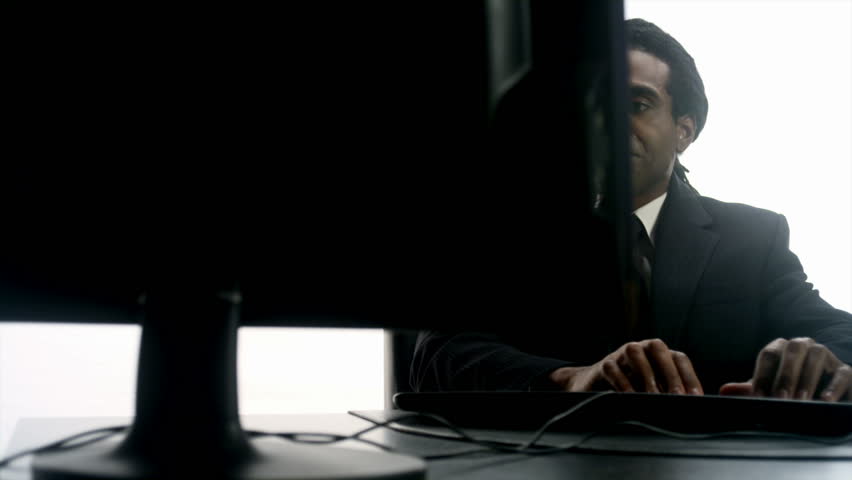 An African man performs tasks in the office. All shot against a white