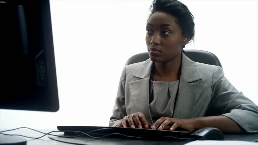 An African woman at a desktop computer 