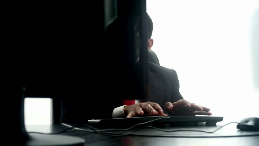 An Hispanic man at a desktop computer 