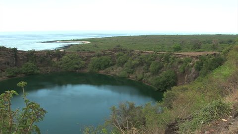 A pan showing the salt lake in Grande Comore in the Comoros between the green tree covered hills